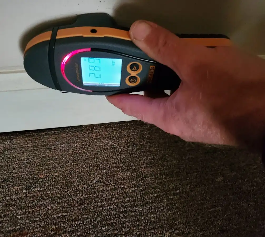 Moisture detection at baseboard during Storm Damage Restoration in Wayne